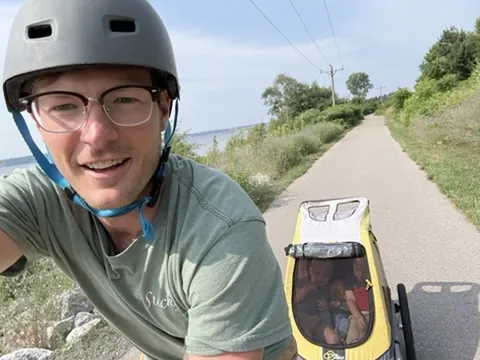 Carson biking with the kids in tow